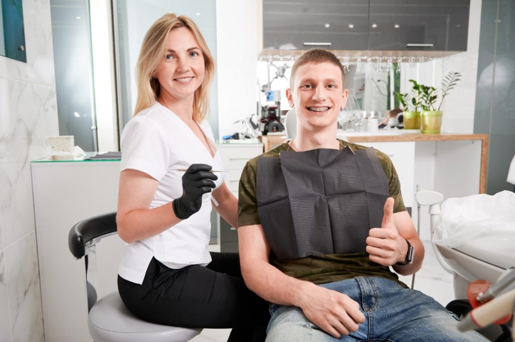 joyful female dentist male patient sitting dental office