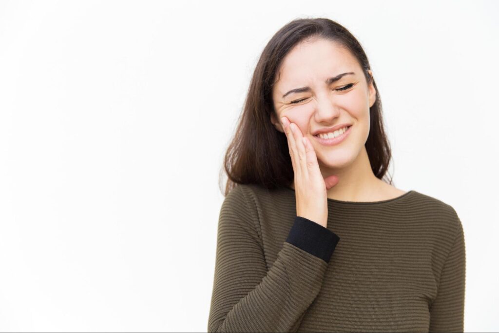 Young women thinking about root canal recovery time and how long does a root canal take to heal
