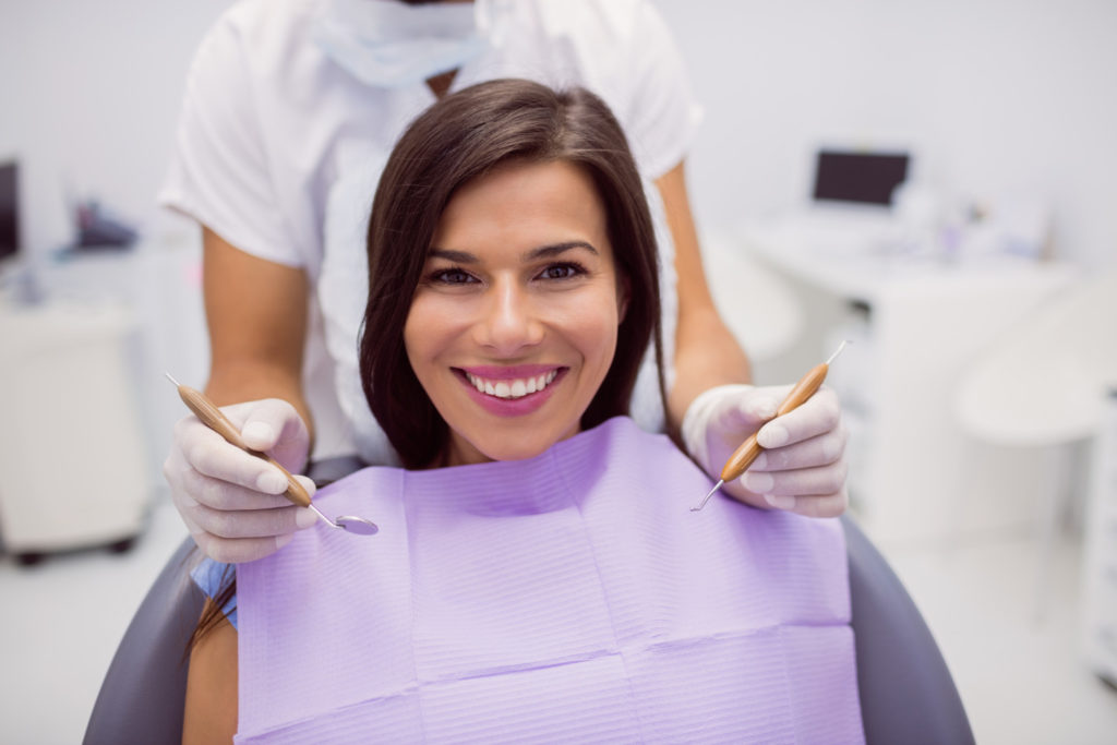 mujer latina joven sonriendo feliz con dientes blancos y saludables descubriendo cuanto cuesta quitar una muela del juicio