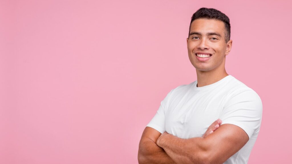 front view smiley man posing with his arms thinking if do braces make you more attractive