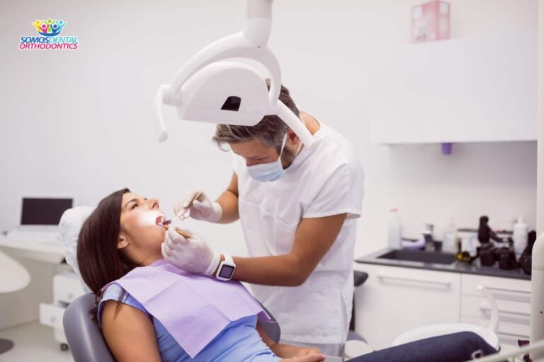 dentist-examining-female-patient-teeth-and-explaining-if-can-orthodontist-fill-cavities