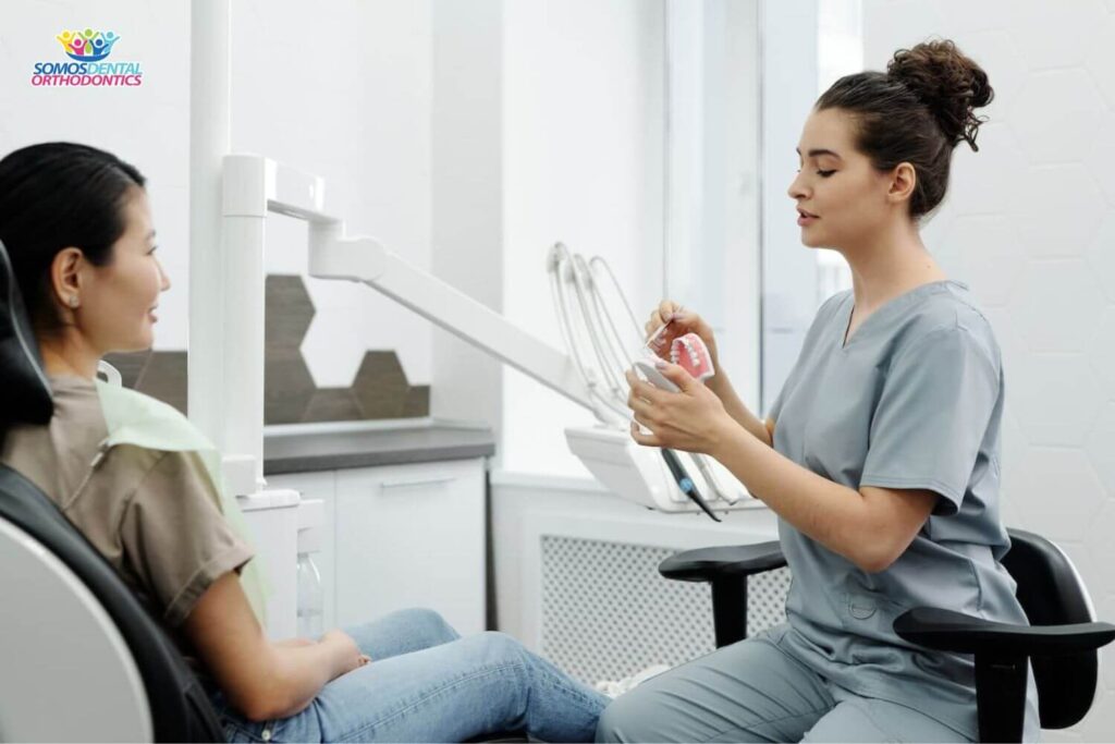 Female-patient-at-dentist-office-with-a-female-dentist-who-explain-if-do-you-have-to-get-wisdom-teeth-removed-for-braces