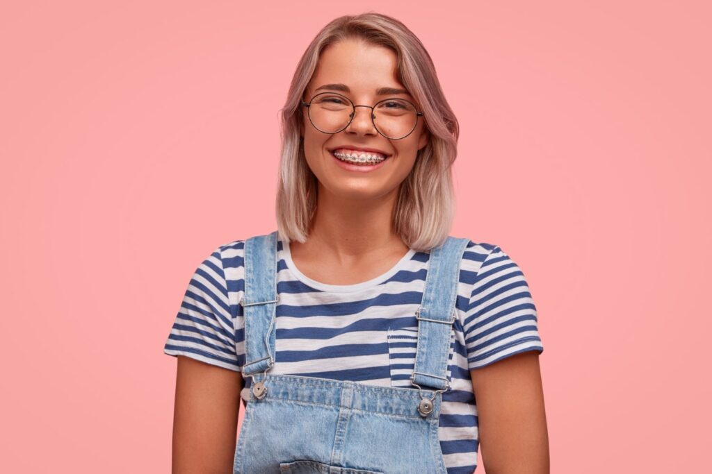portrait young woman with colored hair wearing overalls