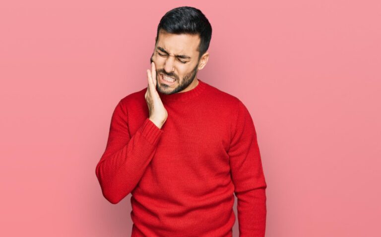 young hispanic man wearing casual clothes touching mouth with hand with painful expression because toothache dental illness wondering what to do before wisdom teeth removal