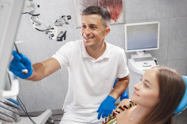 Dentist explaining to patient how to prevent white marks on teeth with braces