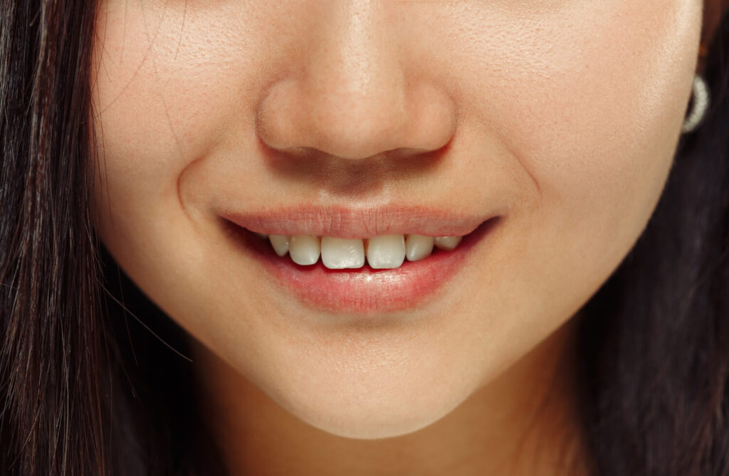 hispanic young woman's close of teeth to explain how long will braces take to close gaps