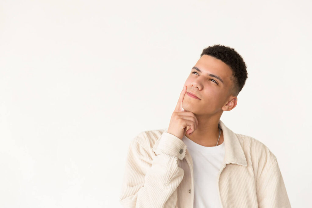 Pensive man with hand on chin looking up