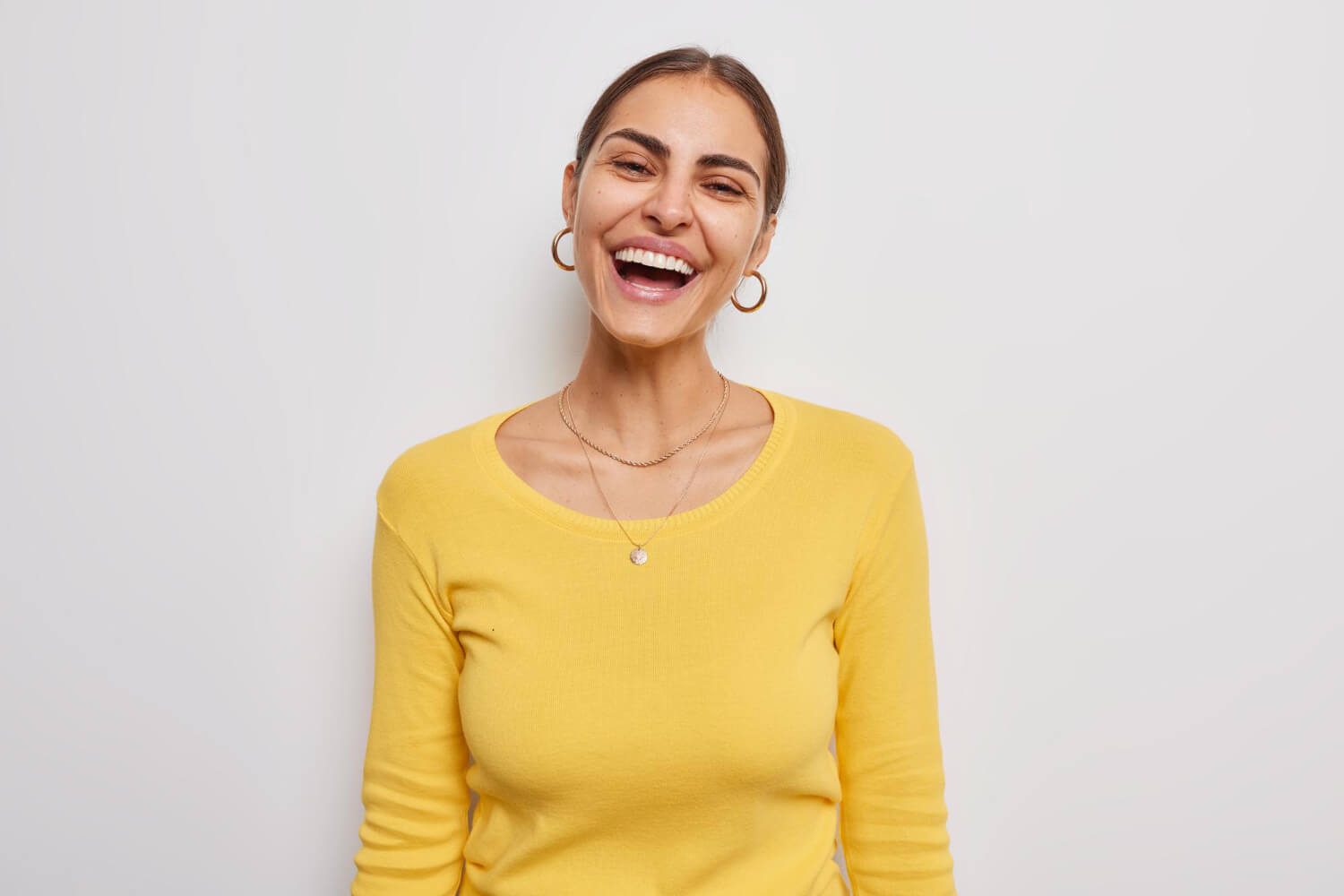 Happy joyful woman smiles broadly shows white teeth
