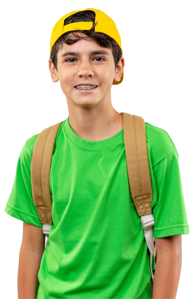 Smiling young school boy wearing backpack with cap