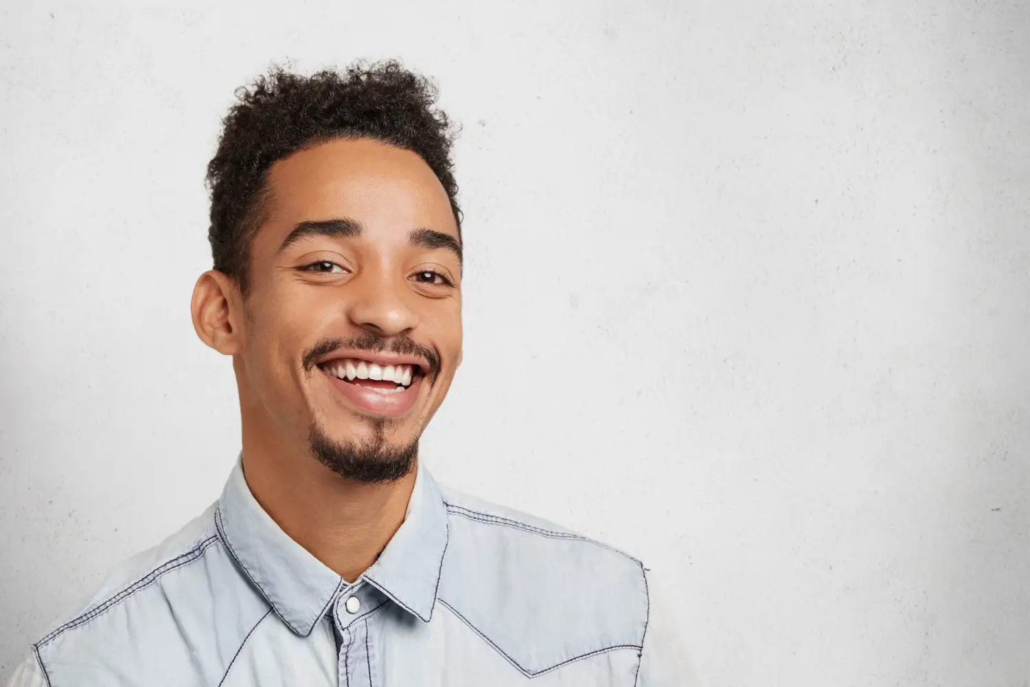 smiling bearded man with trendy hairstyle